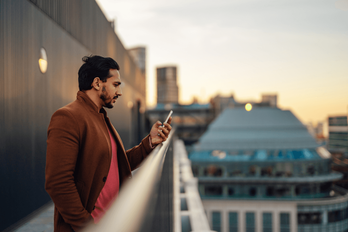 Man outside of a building talking on a phone