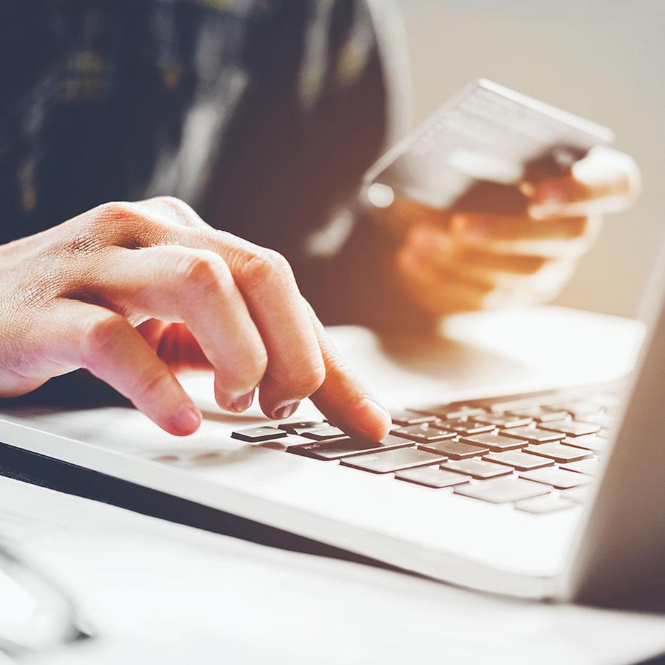 Person entering credit card details on computer