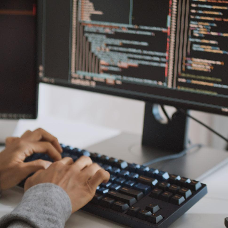 Person coding on a computer