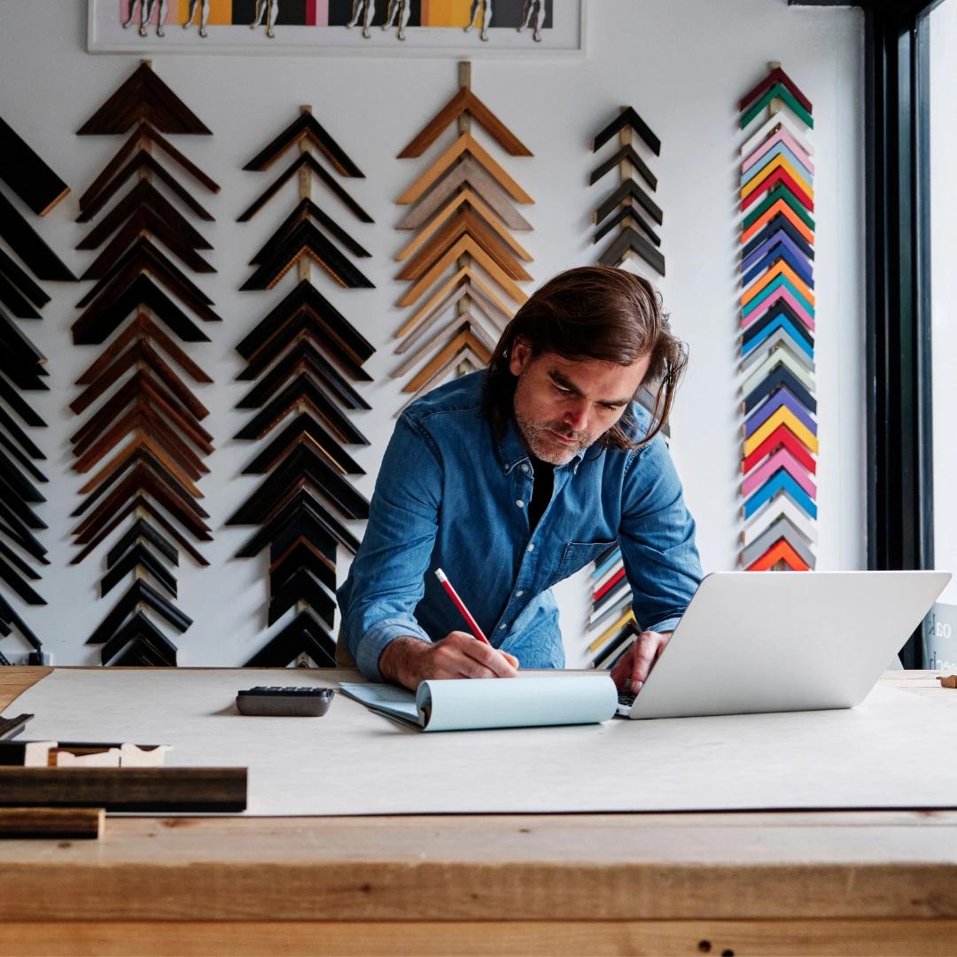 Business owner looks intently at his laptop