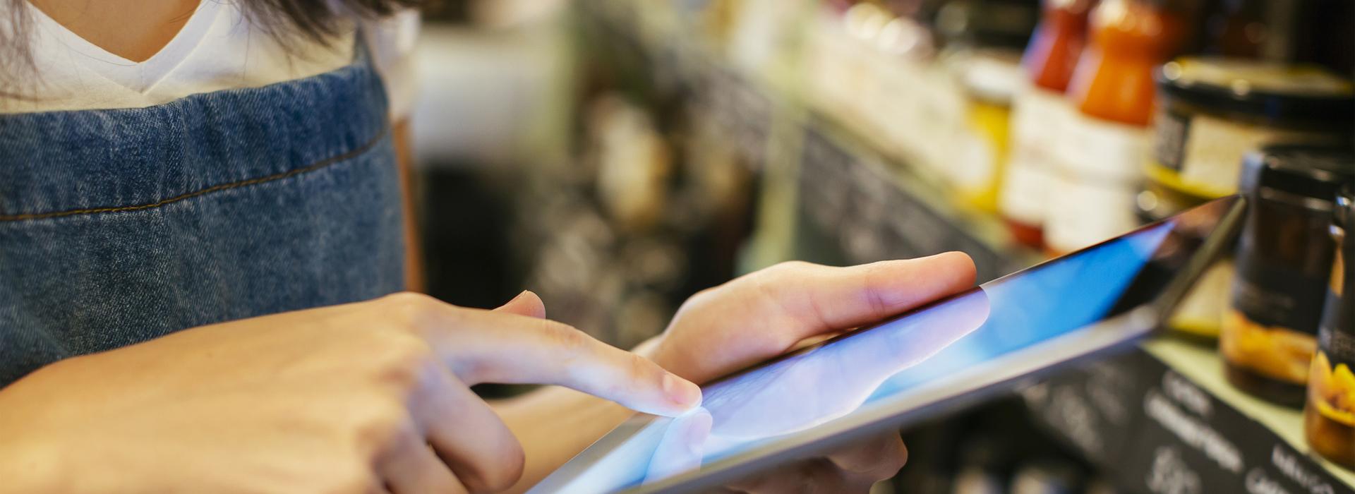 Girl holding tablet in hand (blurred background)