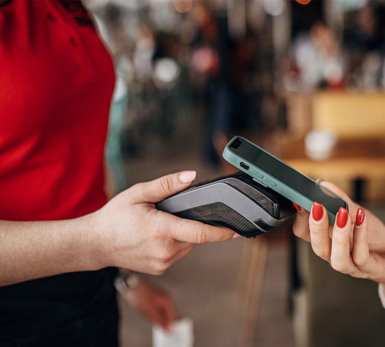 Woman taking a payment on mobile device